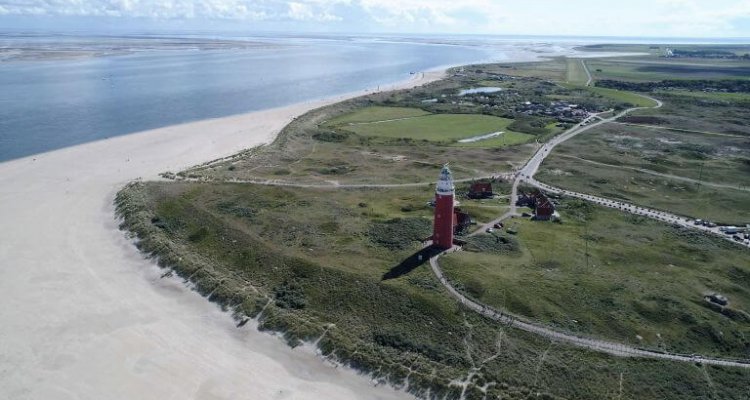 Strand op Texel met uitzicht op vuurtoren