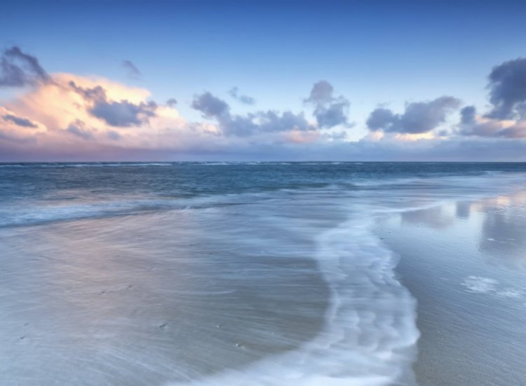 blurred wave on north sea coast at sunrise