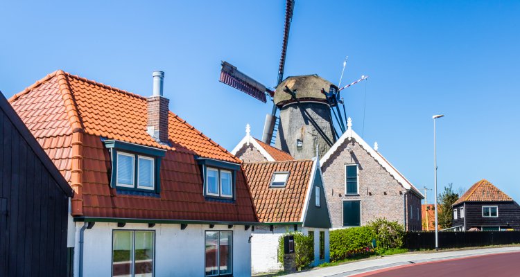 Village Oudeschild with windmill and trraditional fisherman houses on Texel island in the Netherlands