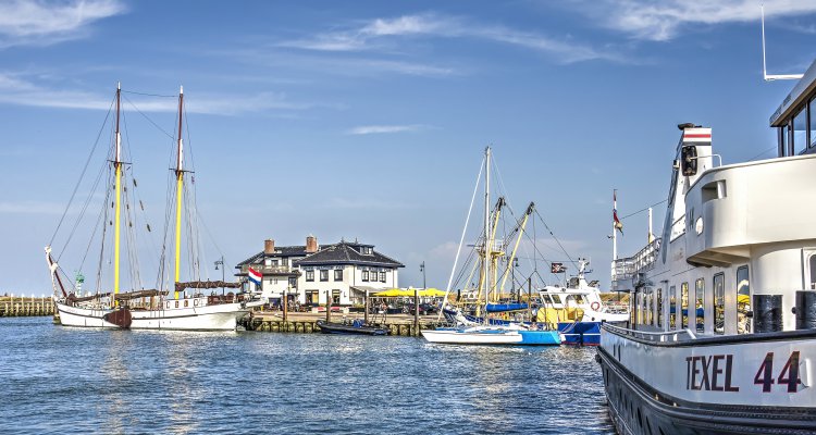 Island of Texel, The Netherlands, July 21, 2018: Several boats and yachts in the harbour of Oudeschild on a sunny summer day