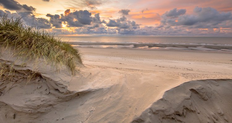 Sunset View on North Sea and Canal fom dunes in Zeeland, Netherlands